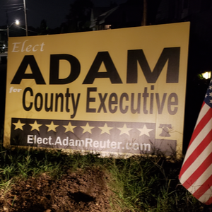 Adam
                    Reuter for Baltimore County Executive yard sign at
                    night